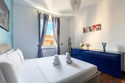 a bedroom with a white bed and a window at Hostly-Roma Clelia Suite-Few Steps from S Giovanni in Rome