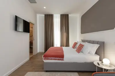 a bedroom with a bed and a television in it at Nox in Rome
