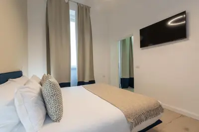 a bedroom with a white bed and a television at Nox in Rome