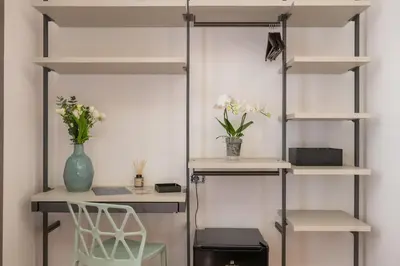a room with shelves and a table and a chair at Nox in Rome