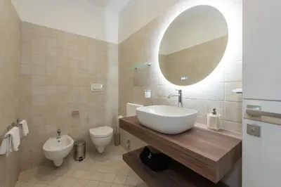 a bathroom with a sink and a toilet and a mirror at Nox in Rome