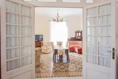 a door leading into a living room with a table and chairs at Trastevere Decò Apartment in Rome