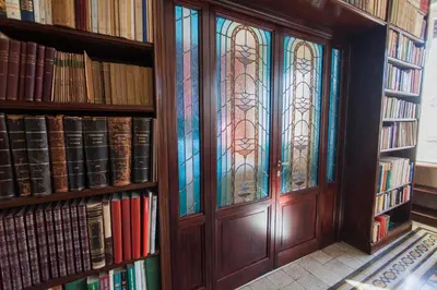 a door with stained glass windows in a library at Trastevere Decò Apartment in Rome