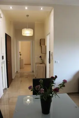a room with a table with a vase of flowers on it at Casa Tony in Rome