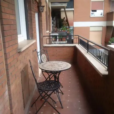 a table and two chairs sitting on a balcony at Casa Tony in Rome