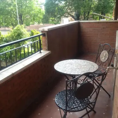 a patio table and chair on a balcony at Casa Tony in Rome