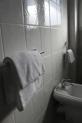 a bathroom with a sink and a white towel at Casa Tony in Rome