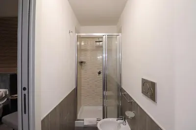 a bathroom with a sink and a mirror at Essenza House Porta Pia in Rome