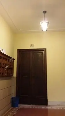 a dark wooden door in a room with a light at Casa Rosy in Rome