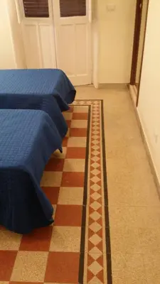 a room with two beds and a checked carpet at Casa Rosy in Rome