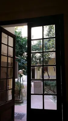 an open door with a view of a building through a window at Casa Rosy in Rome