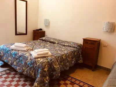 a bedroom with a bed with towels on it at Casa Rosy in Rome