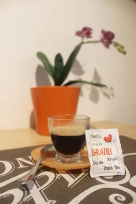 a cup of coffee sitting on a plate next to a drink at B&B Isolatiberina in Rome