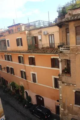 an apartment building with a car parked in front of it at B&B Isolatiberina in Rome