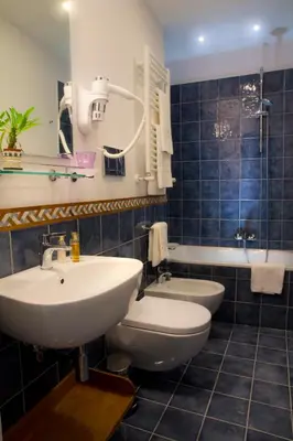 a bathroom with a sink and a toilet and a tub at Ripense In Trastevere in Rome
