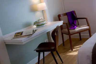 a room with a desk with a chair and a lamp at Ripense In Trastevere in Rome