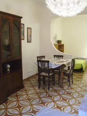 a dining room with a table and chairs and a chandelier at La Casa di Eva in Rome
