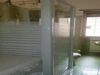 a bathroom with a toilet and a glass shower at La Casa di Eva in Rome