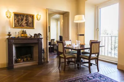 a dining room with a table and a fireplace at Rome Downtown Suite Bed and Breakfast Aracoeli in Rome