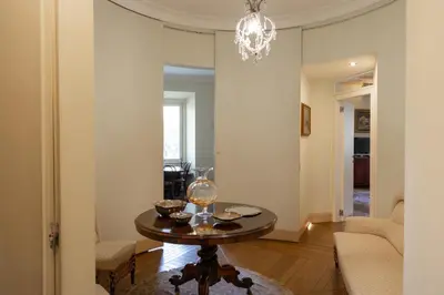 a living room with a table and a chandelier at Rome Downtown Suite Bed and Breakfast Aracoeli in Rome