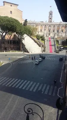 an empty street with cars parked on the side of a building at Rome Downtown Suite Bed and Breakfast Aracoeli in Rome