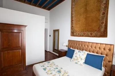 a bedroom with a bed with blue pillows at AD2015 Guest House in Rome