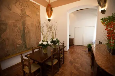 a dining room with a table with flowers on it at AD2015 Guest House in Rome