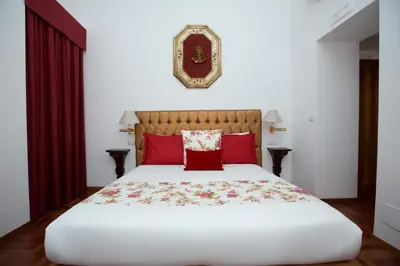 a bedroom with a large white bed with red pillows at AD2015 Guest House in Rome