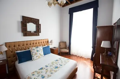 a bedroom with a large bed and a mirror at AD2015 Guest House in Rome