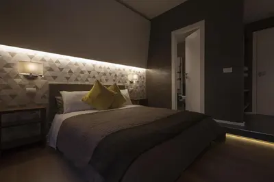 a bedroom with a large bed with yellow pillows at NG Guest House Roma San Pietro in Rome