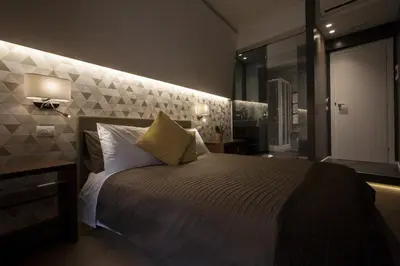 a bedroom with a large bed with a wall at NG Guest House Roma San Pietro in Rome