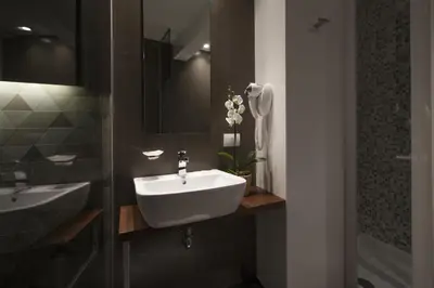 a bathroom with a white sink and a shower at NG Guest House Roma San Pietro in Rome