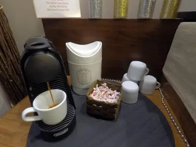 a coffee maker with a cup of coffee and candles at NG Guest House Roma San Pietro in Rome