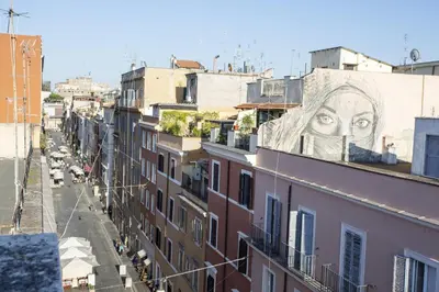 a mural of a face on the side of a building at Borgo Panoramico - 3-Bedroom Apartment with Terrace - LOCAPPART in Rome