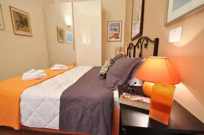 a bedroom with a bed and a table with a lamp at Casa Visconti in Rome
