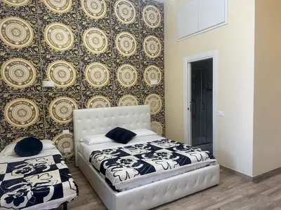 a bedroom with two beds in front of a wall at Lin Mare in Rome