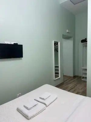 a bedroom with a bed with two towels on it at Lin Mare in Rome