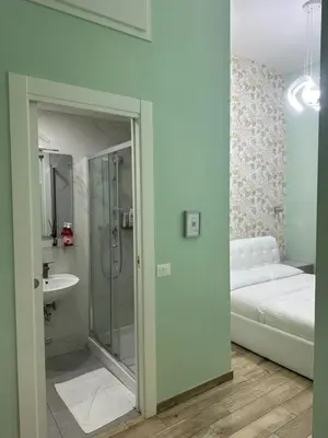 a bathroom with a shower and a bed and a sink at Lin Mare in Rome