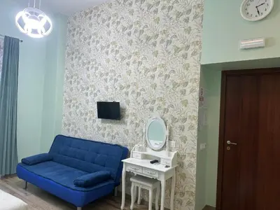 a living room with a blue couch and a mirror at Lin Mare in Rome