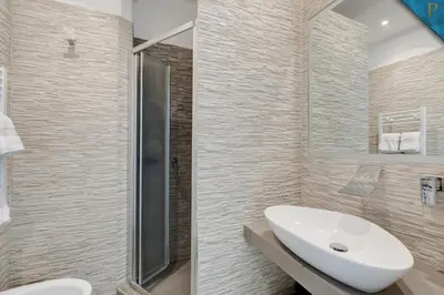 a bathroom with a sink and a shower at Piccolotel in Rome