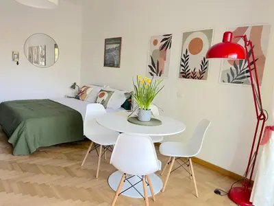 a bedroom with a bed and a table and chairs at Delmirani's Book Apartments - Vatican View in Rome