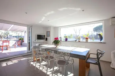 a kitchen and dining room with a table and chairs at Delmirani's Book Apartments - Vatican View in Rome
