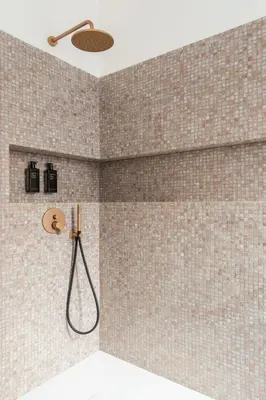 a shower in a bathroom with brown tiled walls at Bright Family 5BR Apartment in Parioli in Rome