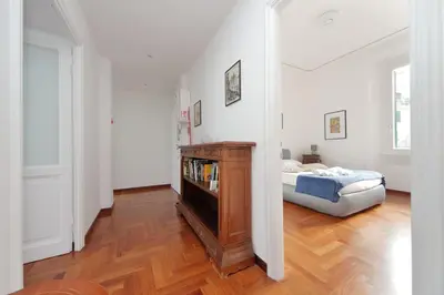 a living room with a bed and a book shelf at 4BNB - St. Peters Dome Apartment in Rome