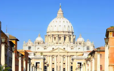 a large white building with a dome on top of it at Saint Peter Welcoming Apartment in Rome