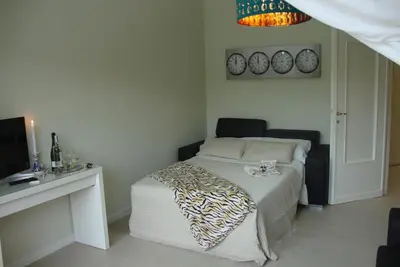 a bedroom with a bed and a desk and a television at Saint Peter Welcoming Apartment in Rome