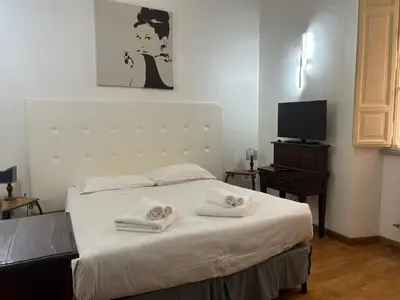 a bedroom with a bed with towels on it at San Vitale 18 by GHOR in Rome