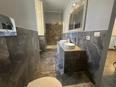 a bathroom with two sinks and a shower at San Vitale 18 by GHOR in Rome