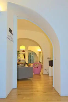an archway in a living room with a couch at CasaBlanca Apartment in Rome