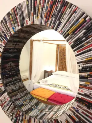 a room with a bed and a mirror with dvds at CasaBlanca Apartment in Rome